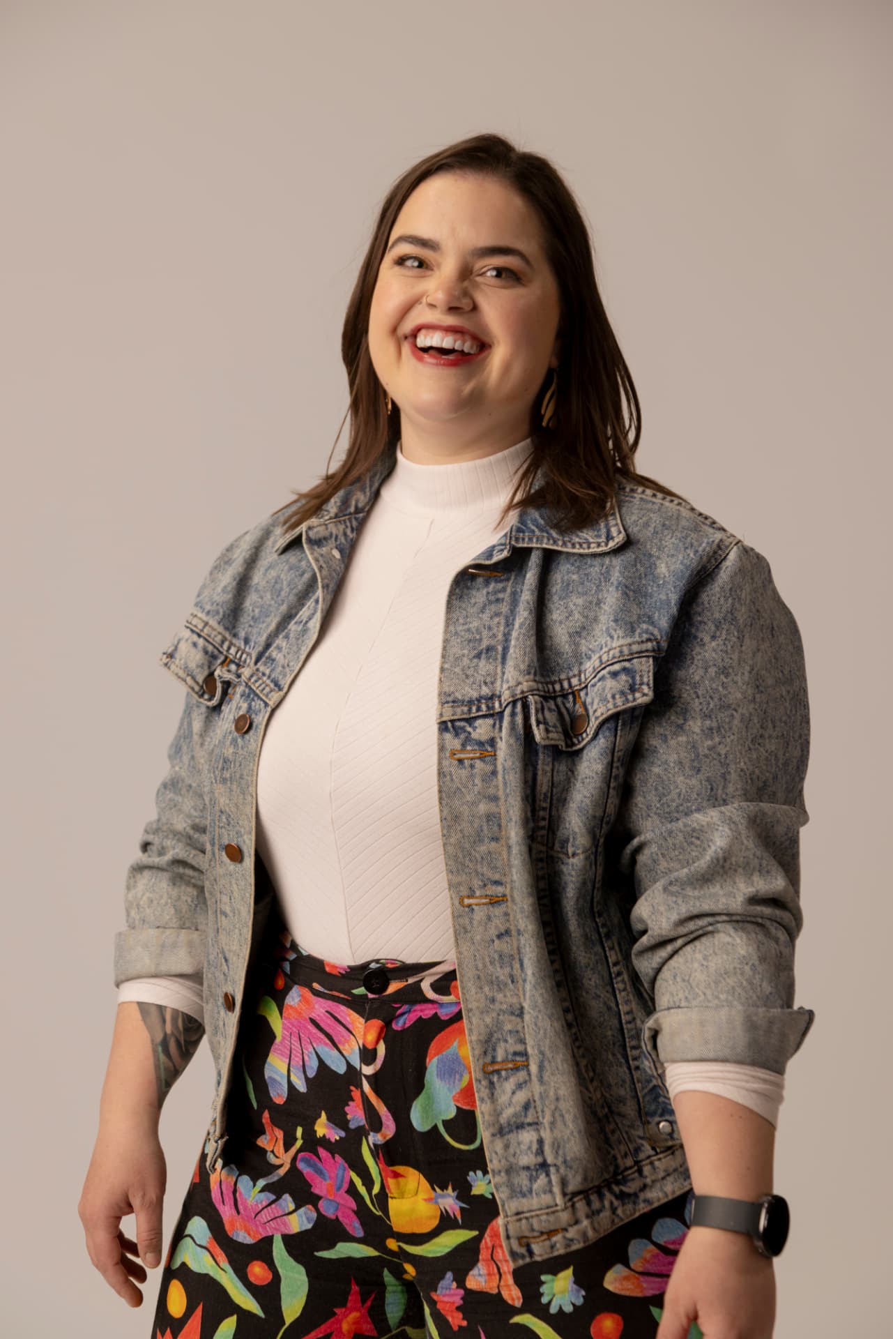 Brooke Rose smiling in a denim jacket