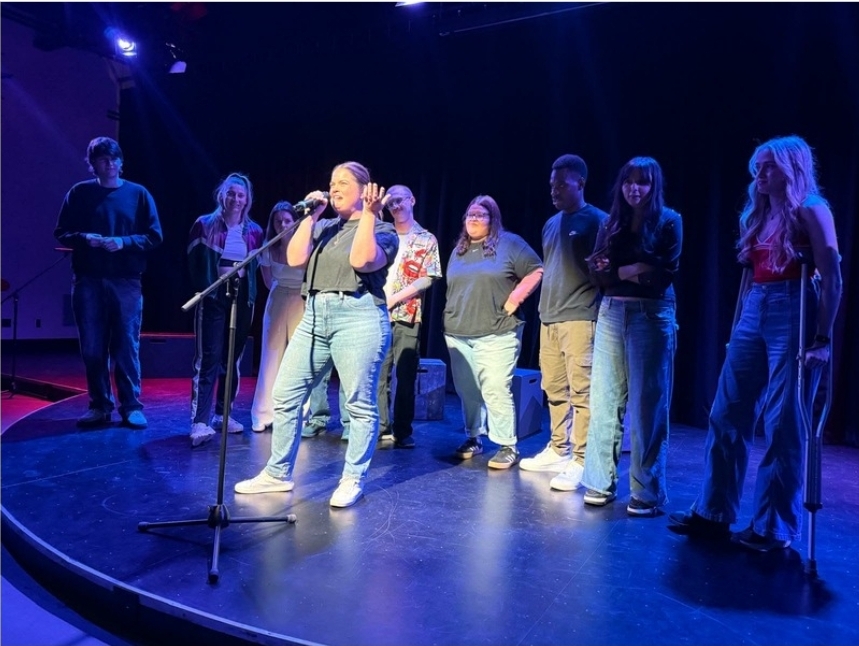 Brooke performing with an ensemble on stage
